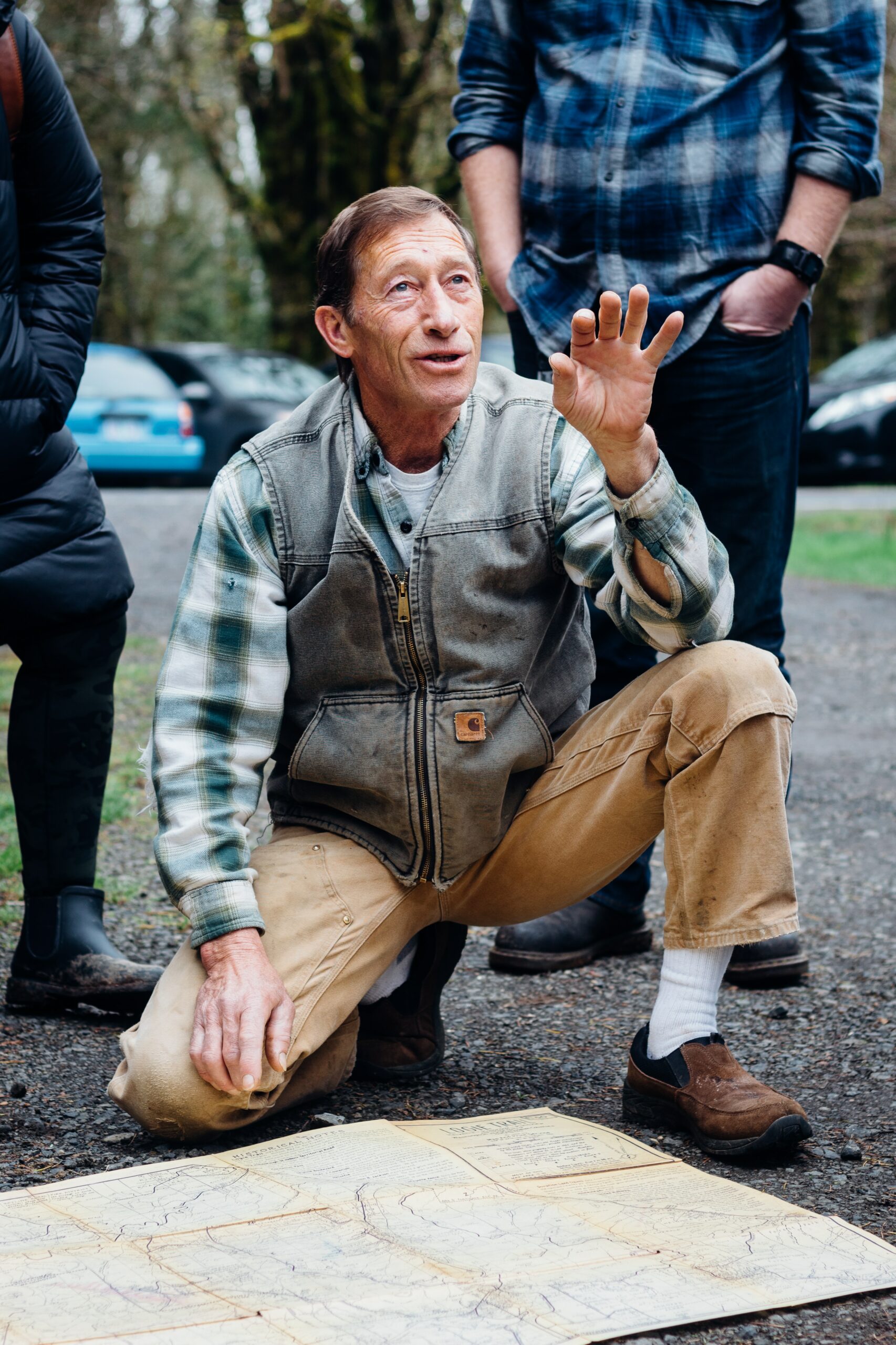 man kneeling doing hand signs