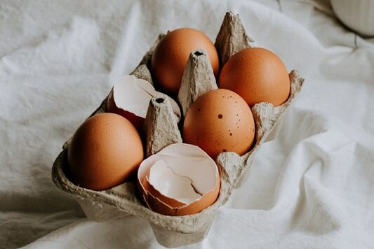 brown eggs on white textile