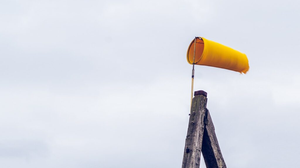 yellow air lantern on brown wooden post