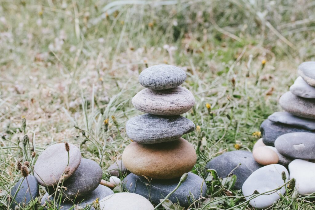 stack of stones on green grass during daytime