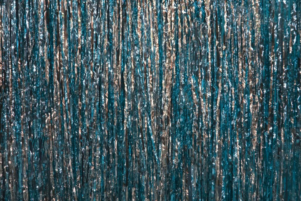 a blue curtain with silver foil on it
