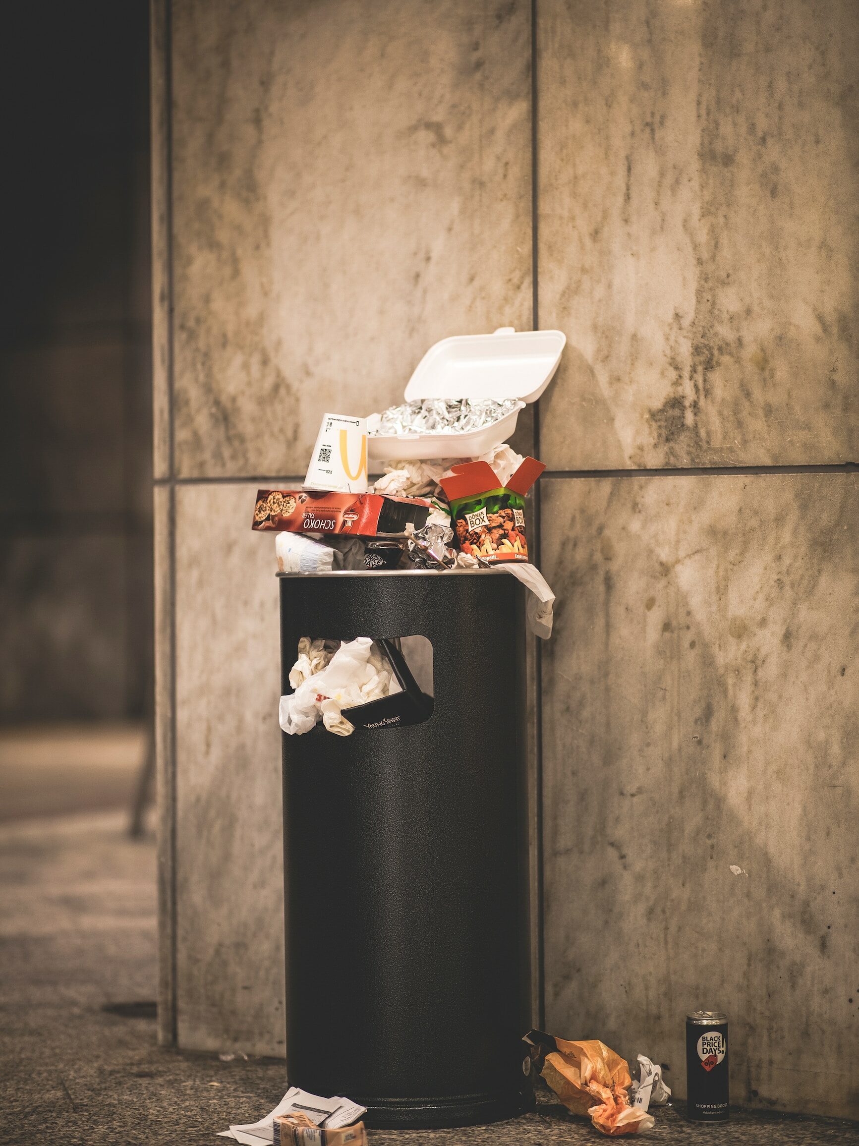 black and white plastic trash bin